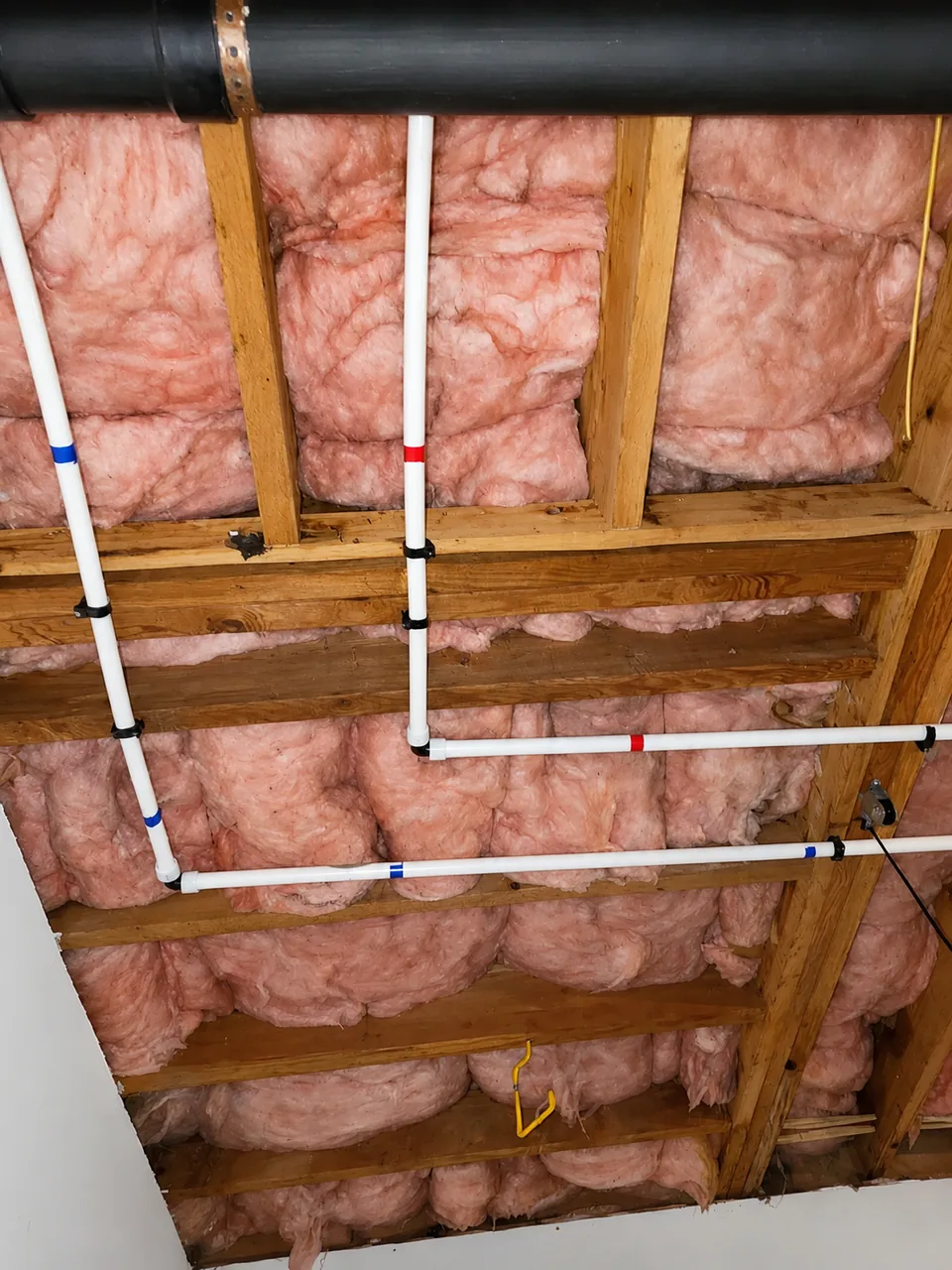 New PEX water supply lines routed through the floor joists during a whole home repipe in Metro Atlanta